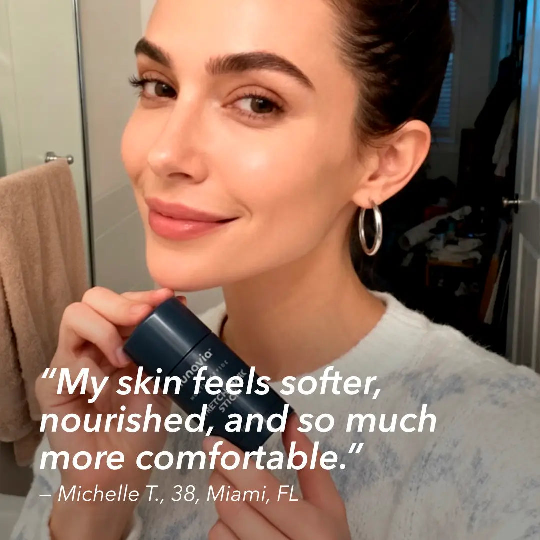 Woman holding Lunavia™ Stretch Mark Stick with review about softer, nourished skin
