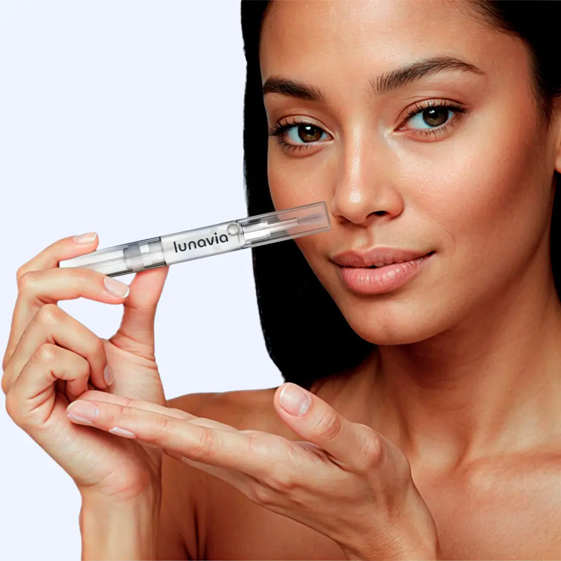 Woman holding Lunavia antifungal pen applicator near face, showcasing product