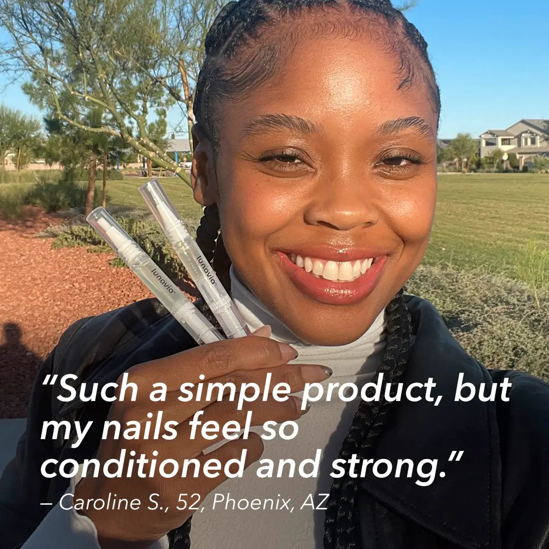 Woman holding Lunavia™ Nail Strengthening Pens with review about stronger nails