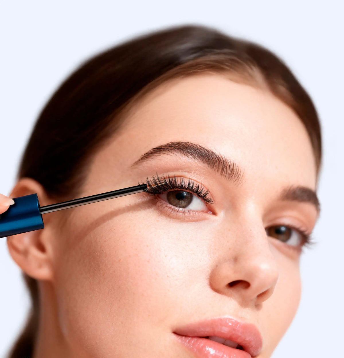 woman applying eyelash serum with precision brush