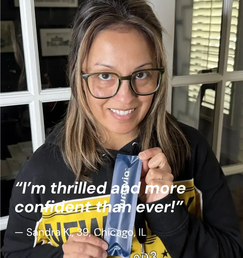 Woman holding Lunavia antifungal  pen with testimonial about increased confidence